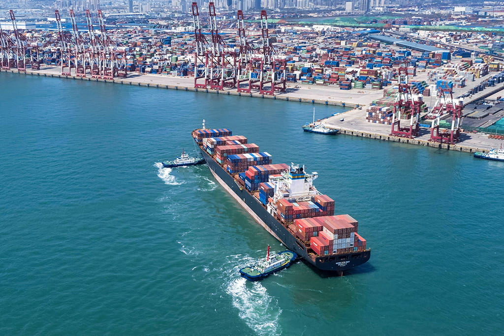 Container ship used for international sea freight, transporting large cargo containers across the ocean.
