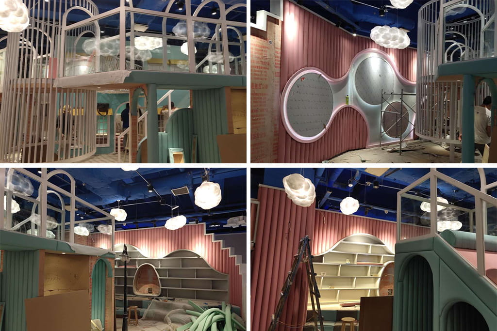 Indoor playground equipment installation process showing workers assembling the structure on site.