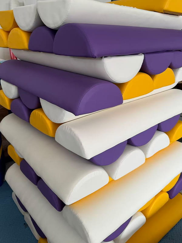 Soft play padding production with high-density foam wrapped in durable PVC, creating colorful and safe protective components for kids playgrounds