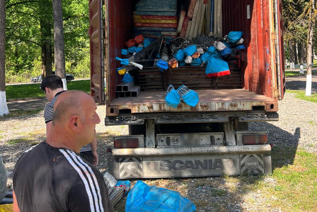 Customer unloading the Hooplo playground equipment from the container in Tskaltubo, Georgia, marking the arrival of the custom indoor-outdoor playground and bumper cars